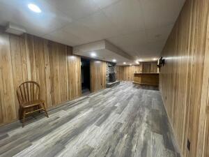 interior space featuring wood walls and wood-type flooring