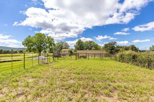 view of yard with a rural view and fence