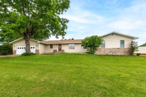 ranch-style home with a front yard and a garage