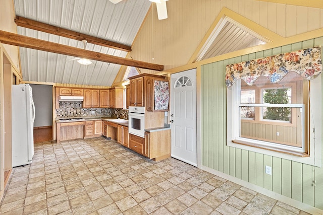 kitchen featuring ceiling fan, wood walls, white appliances, and lofted ceiling with beams