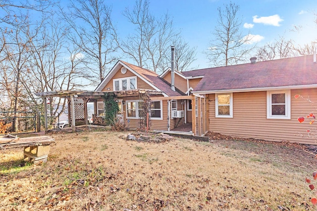 back of house featuring cooling unit, a yard, and a pergola