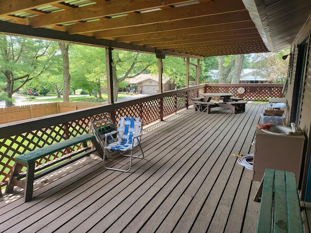 wooden terrace featuring a storage shed and a pergola