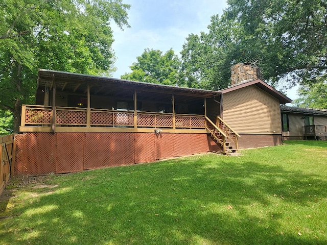 rear view of property featuring a lawn