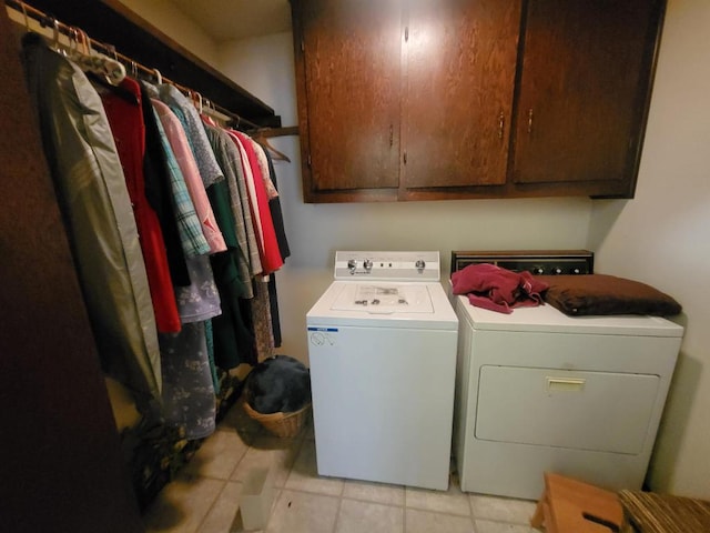 laundry room with cabinets, separate washer and dryer, and light tile patterned floors