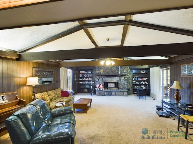 living room featuring a stone fireplace, lofted ceiling with beams, wooden walls, and carpet