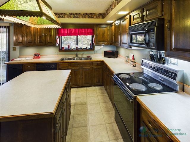 403 Normandy St, Harrison, AR 72601 - kitchen with black appliances, light countertops, plenty of natural light, and a kitchen island