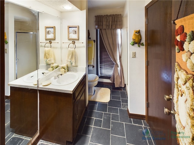 bathroom with vanity, toilet, tile patterned floors, and a shower with door