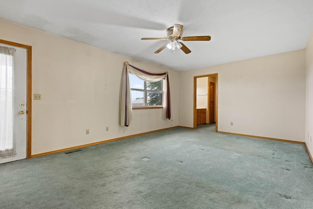 carpeted empty room featuring ceiling fan