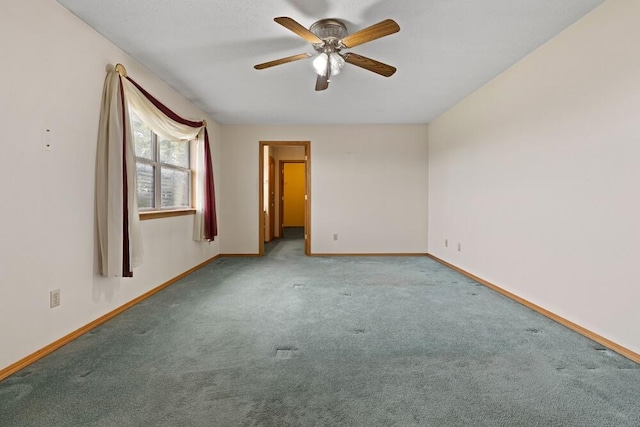 empty room featuring light colored carpet and ceiling fan