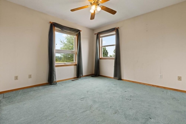 spare room featuring ceiling fan and light carpet