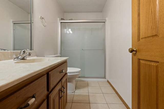 bathroom with a shower with shower door, toilet, tile patterned flooring, and vanity