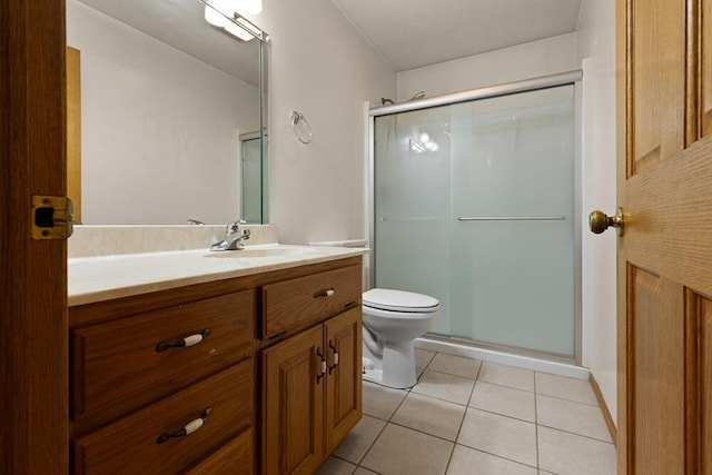 bathroom featuring tile patterned flooring, toilet, vanity, and a shower with shower door