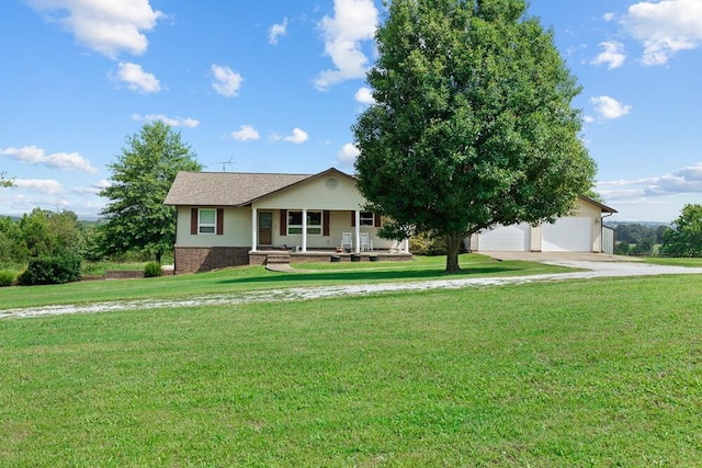 view of front facade featuring a garage, a front lawn, and covered porch