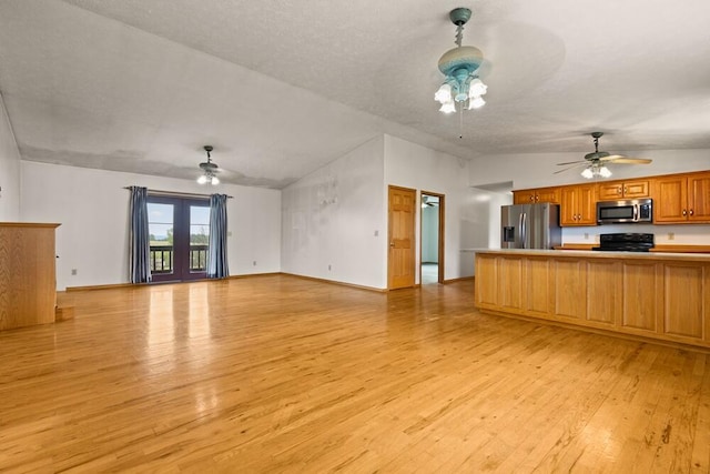 unfurnished living room featuring ceiling fan, light wood-type flooring, and lofted ceiling