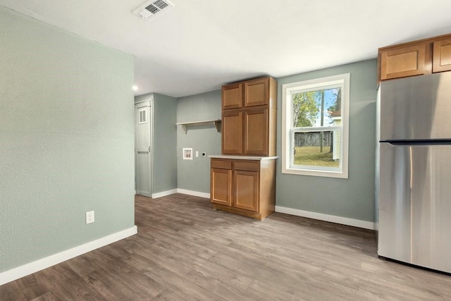 kitchen featuring light hardwood / wood-style floors and stainless steel refrigerator