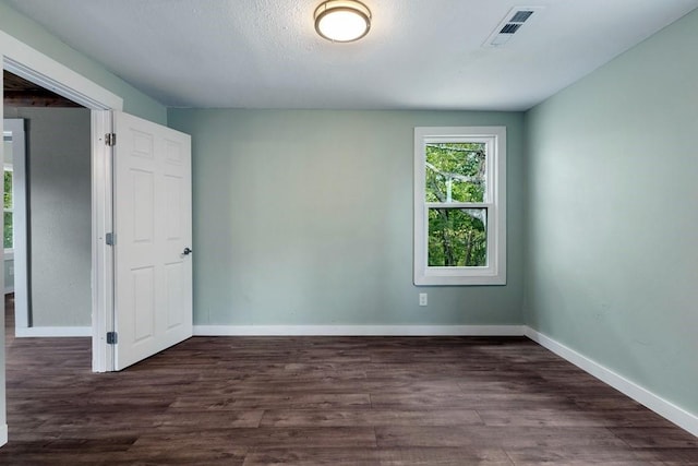 empty room with dark hardwood / wood-style floors