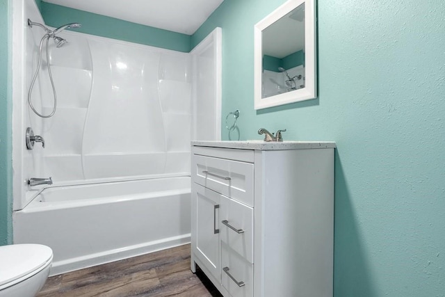 full bathroom with bathing tub / shower combination, hardwood / wood-style flooring, toilet, and vanity