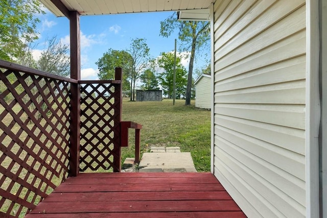 wooden terrace featuring a lawn