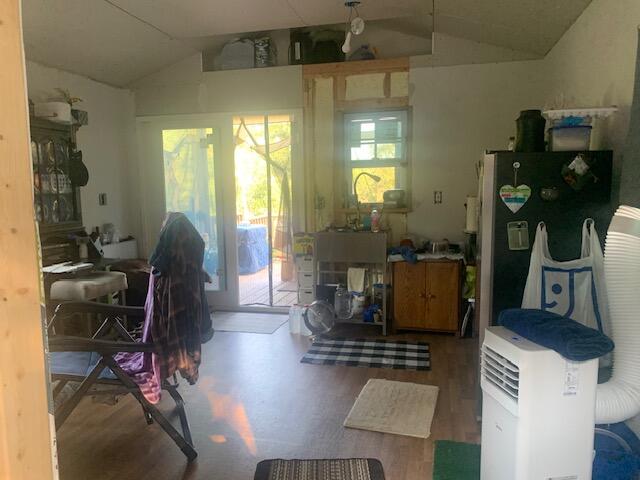 interior space featuring plenty of natural light, vaulted ceiling, and hardwood / wood-style floors