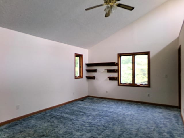 spare room with carpet flooring, ceiling fan, and vaulted ceiling