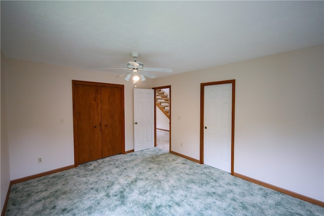 unfurnished bedroom with ceiling fan and light carpet