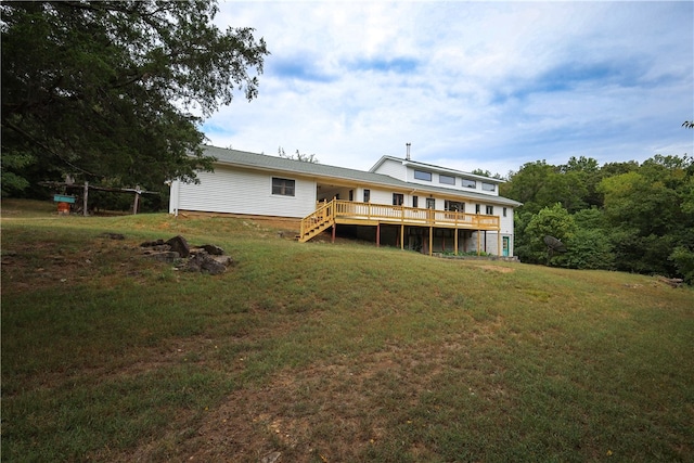 back of house featuring a yard and a deck