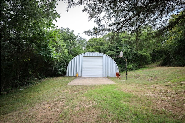 view of outbuilding with a lawn and a garage