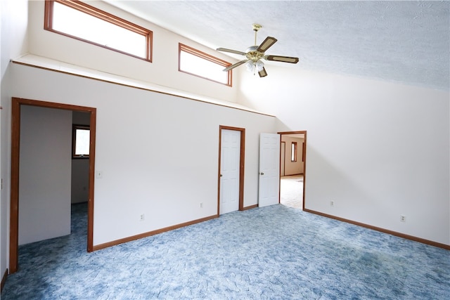 spare room with ceiling fan, carpet, and a textured ceiling