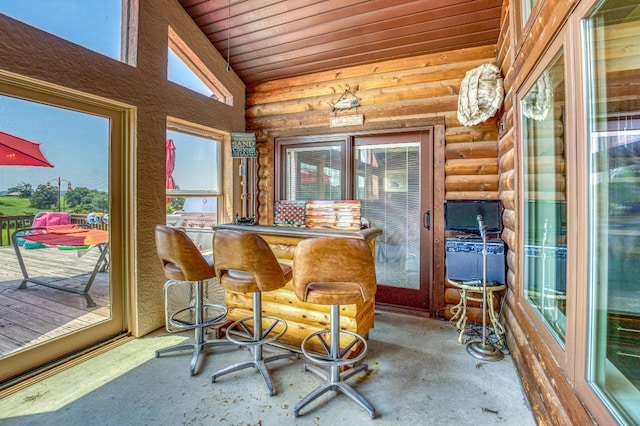 sunroom featuring vaulted ceiling