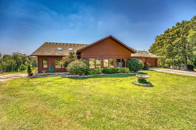 view of front of home featuring a garage and a front lawn