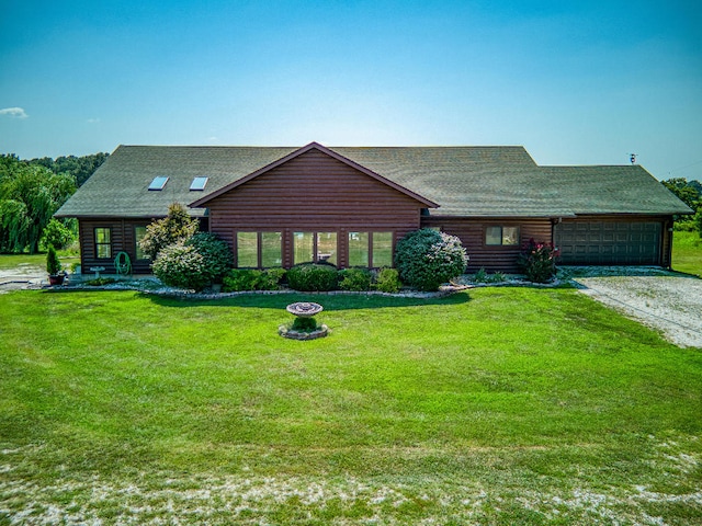 view of front of property with a garage and a front yard