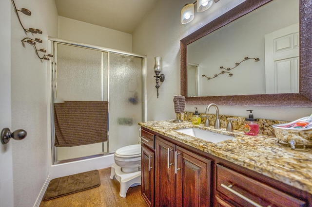 bathroom with toilet, vanity, walk in shower, and tile patterned floors