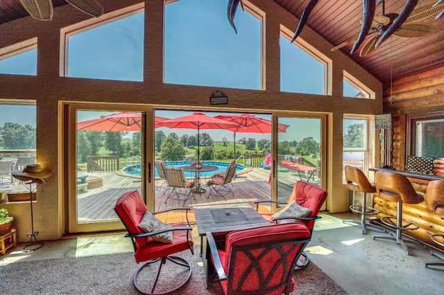 sunroom featuring vaulted ceiling and wood ceiling