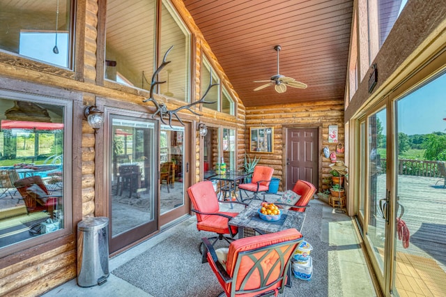 sunroom featuring ceiling fan, vaulted ceiling, and wood ceiling