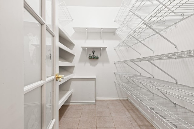 walk in closet with tile patterned floors