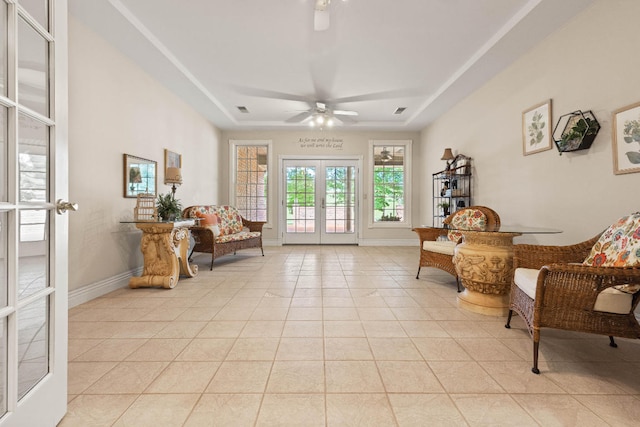 living area with french doors, ceiling fan, and light tile patterned floors