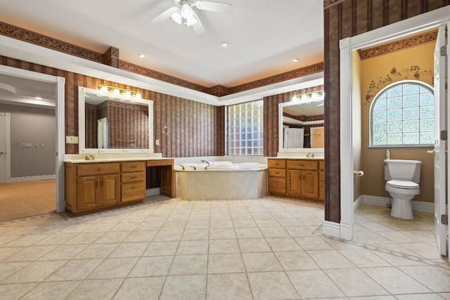 bathroom with a tub to relax in, vanity, toilet, and tile patterned flooring