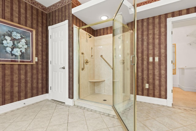 bathroom featuring wallpapered walls, a shower stall, and tile patterned flooring