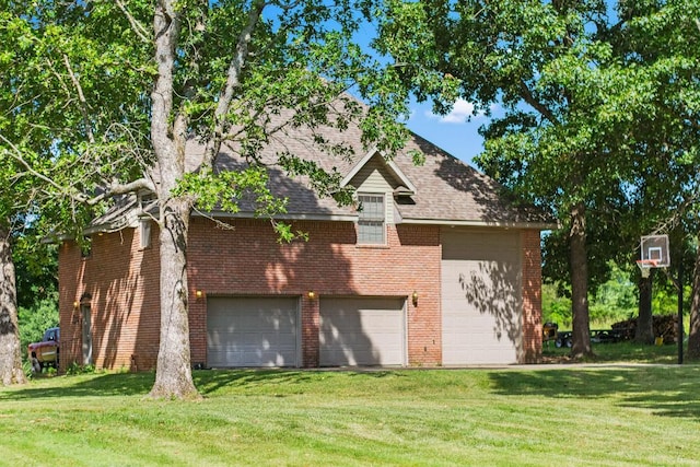 exterior space with a garage, a yard, brick siding, and roof with shingles