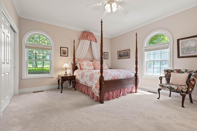 bedroom featuring crown molding, multiple windows, light colored carpet, and ceiling fan