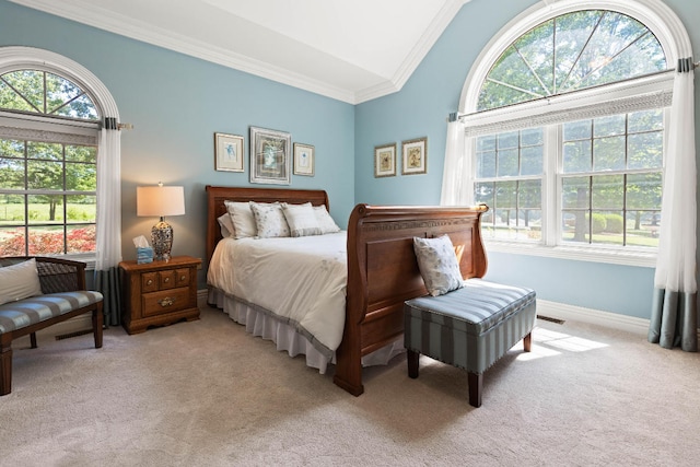 bedroom with light carpet, baseboards, vaulted ceiling, and crown molding