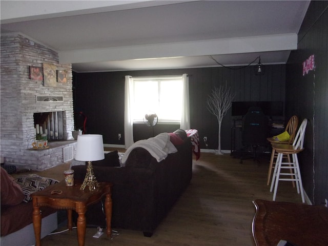 living room with a fireplace, vaulted ceiling, and hardwood / wood-style floors