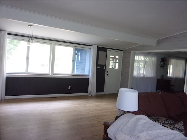 entrance foyer featuring lofted ceiling with beams and light hardwood / wood-style flooring