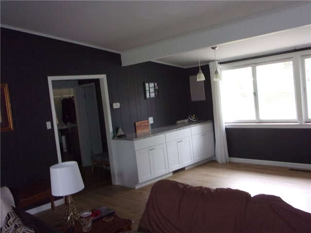 bedroom featuring light hardwood / wood-style flooring, ornamental molding, a closet, and beam ceiling