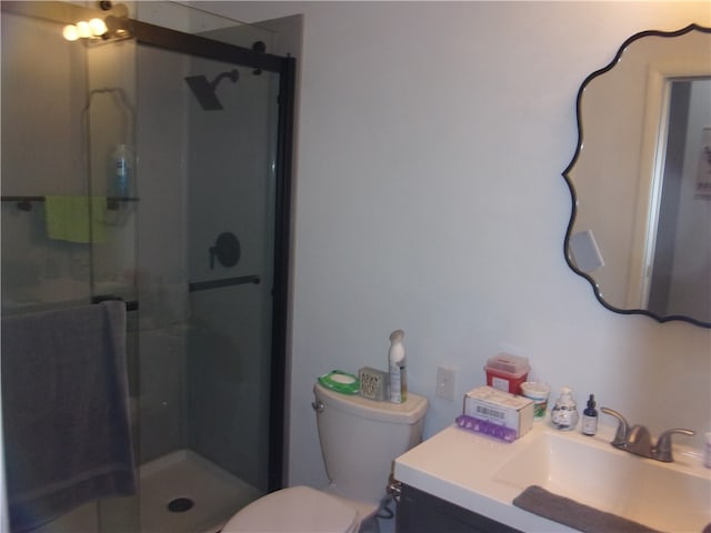 bathroom featuring an enclosed shower, vanity, and toilet