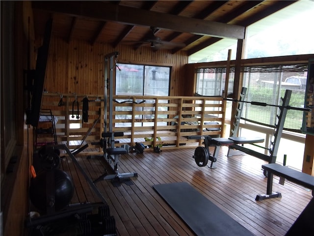 exercise room with hardwood / wood-style floors, vaulted ceiling, wooden walls, ceiling fan, and wooden ceiling