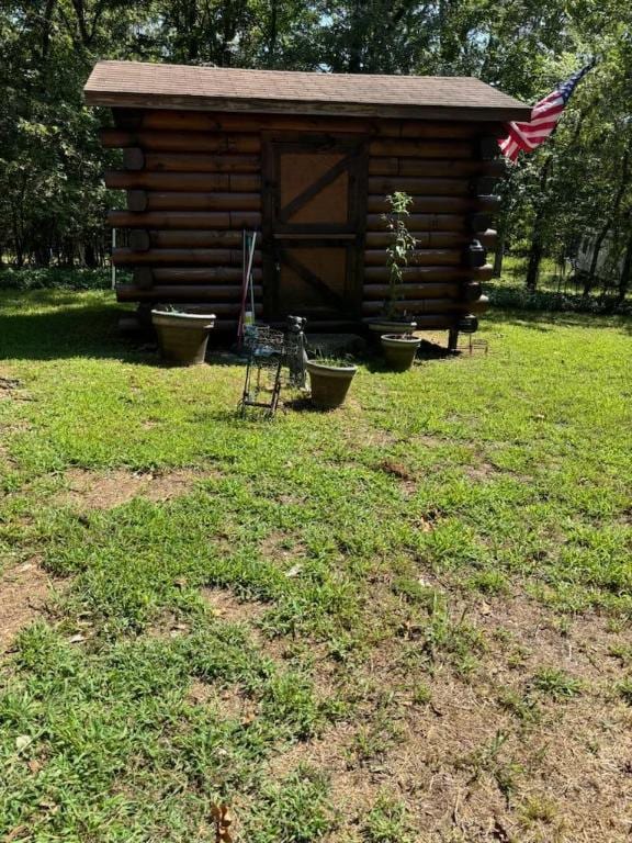 view of outbuilding featuring a yard