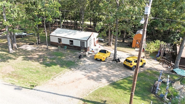 view of front of house featuring a storage unit