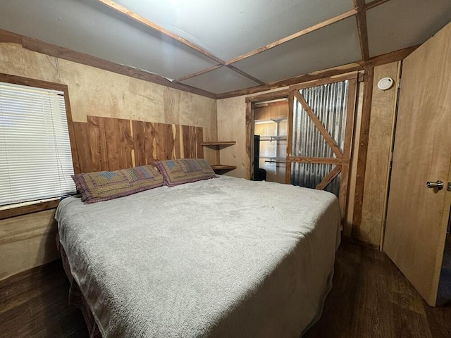 bedroom with dark hardwood / wood-style floors