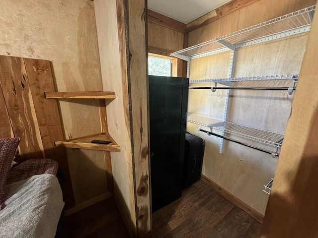 bathroom with hardwood / wood-style floors and wood walls